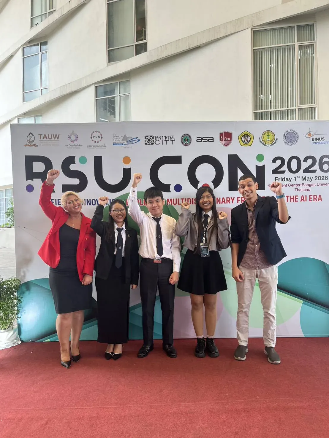 The team with mentors and collaborators in front of the RSUCON 2026 banner