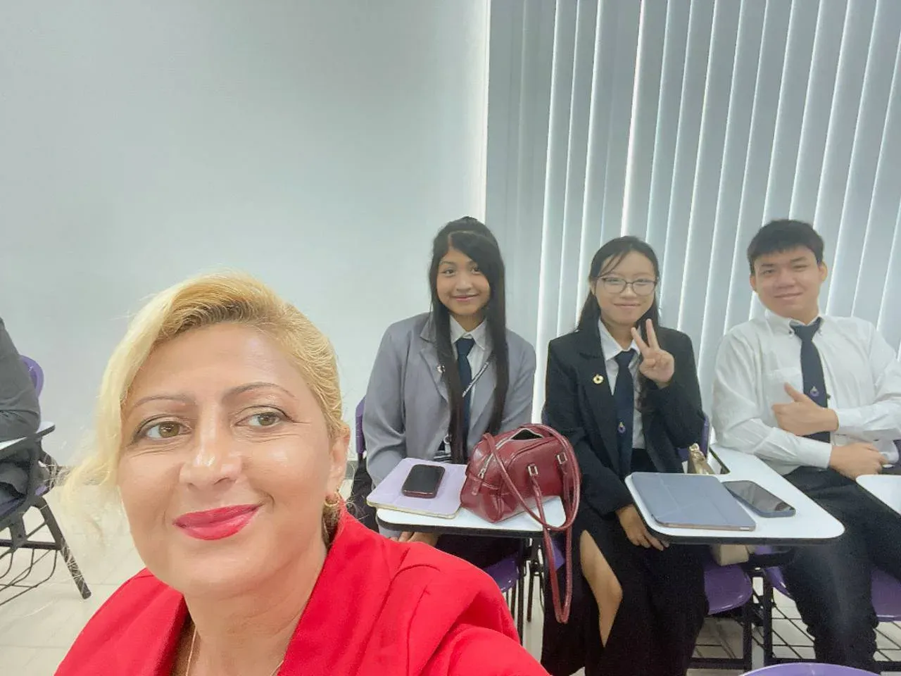 A selfie in a conference room, with members of the research team seated behind