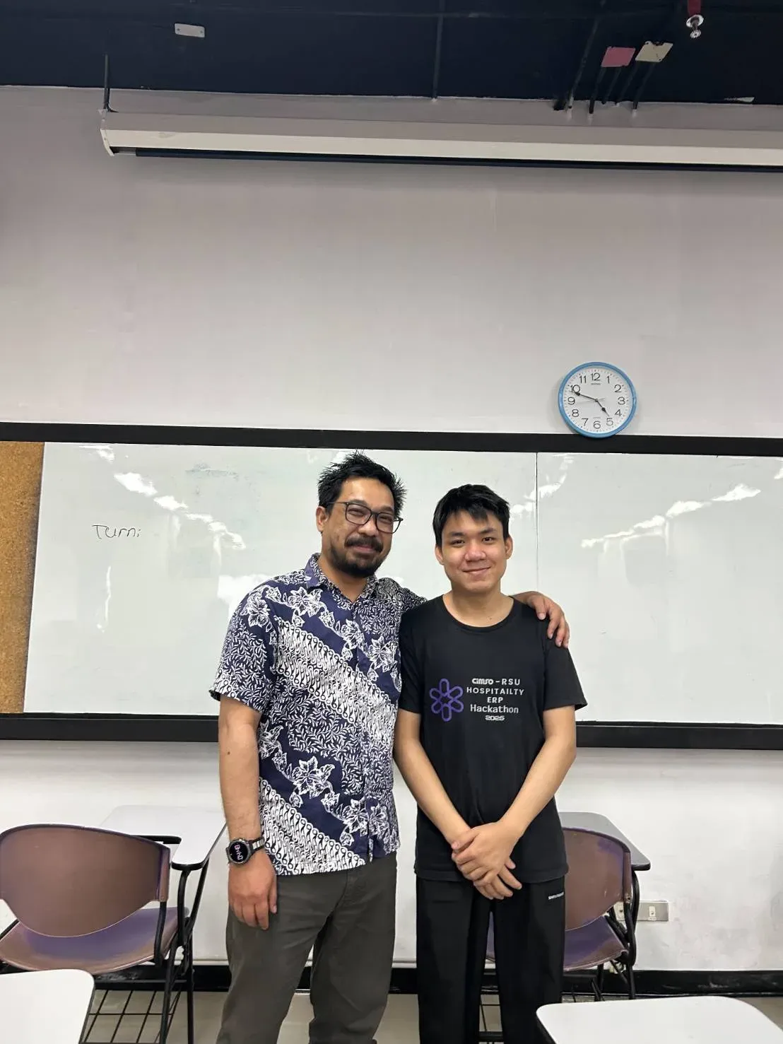 Kyaw Swar Hein standing with Dr. Herison Surbakti in a classroom