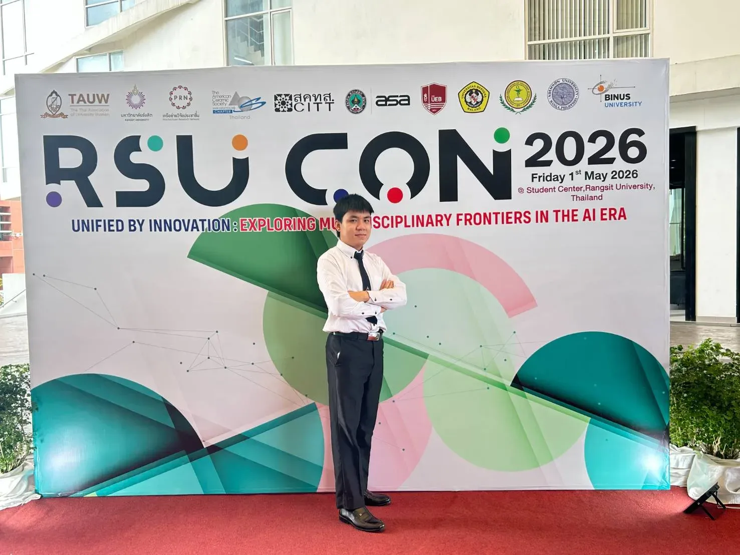 Kyaw Swar Hein in a white shirt and tie in front of the RSUCON 2026 conference banner