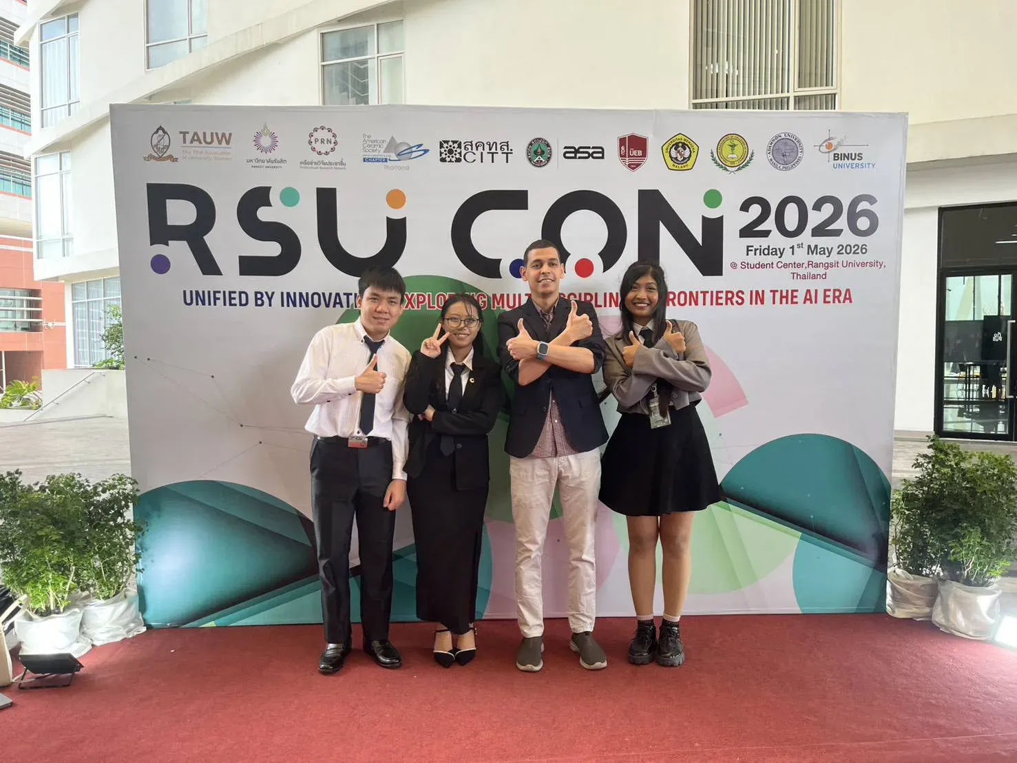 The research team in front of the RSUCON 2026 conference banner